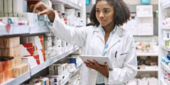 A pharmacy student checks medicine inventory